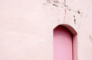 vintage style arch door on the old wall day view