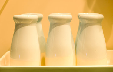 white color milk bottles display in the box