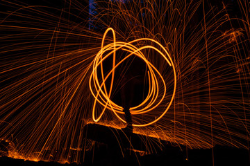 Drawing light at night in an old abandoned building, splashes of light and sparks. Freezelight.