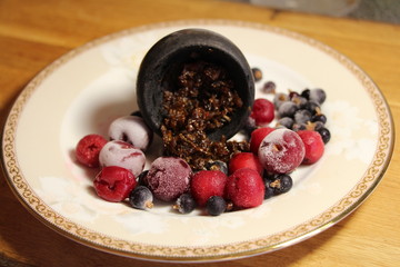 bowl with tobacco for hookah. berries on a black background