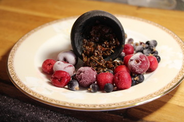 bowl with tobacco for hookah. fruits on a black background