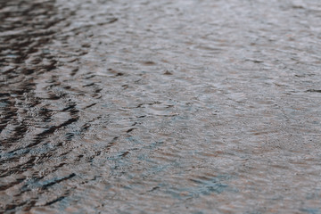 Ripples on the water. Beautiful background with water and small waves.