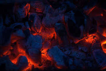 Hot coals in a bonfire. Red-hot red embers of a barbecue. Burning fire