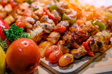 Grilled  meat skewers on the wood background.