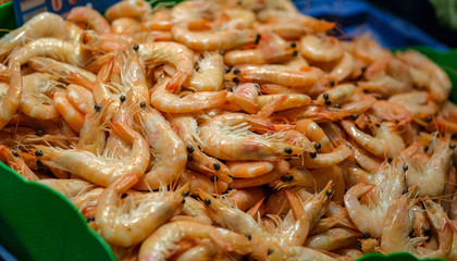 Fresh shrimps or prawns raw on a market counter. Fresh seafood, mediterranean diet. Background texture.