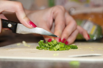 woman cutting vegetables in kitchen