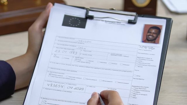 Woman looking through citizenship application, European union flag on document