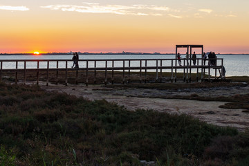 Fototapeta na wymiar Wooden jetty at dusk in the bay of San Fernando