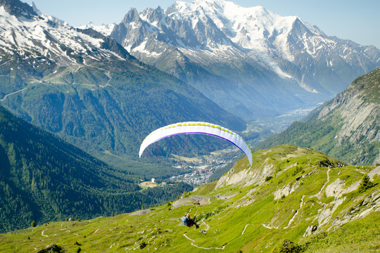 A paraglider flying towards Mont Blanc in the Chamonix Valley