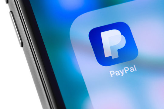 PayPal logo on the screen smartphone. Paypal is an internet based digital money transfer service. Moscow, Russia - March 15, 2019
