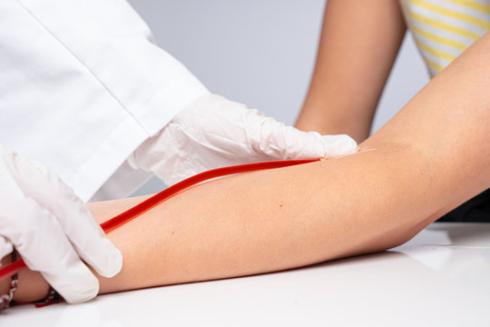 a doctor puts a cannula on the arm of a patient