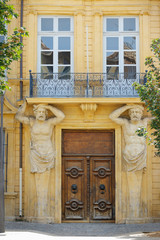 stone statue sculpture supporting balcony ,mediterranean architectural building