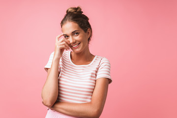 Fototapeta premium Image of content beautiful woman wearing striped clothes smiling and rejoicing at camera