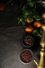 bowl with tobacco for hookah. passion fruit on a dark background. smoking hooka