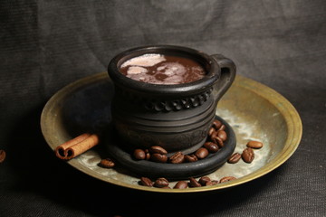 cup of coffee with beans on black background