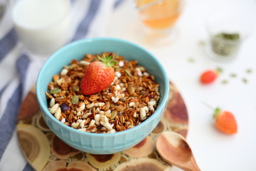 Fototapeta na wymiar granola with strawberries in a plate on a white table