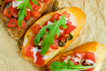 Bruschetta with cheese and tomato. Close-up.