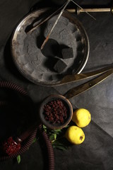 bowl with tobacco for hookah. berries on a black background