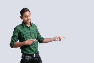 young indian college student showing direction