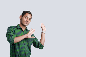 young indian college student showing direction