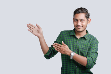 young indian college student showing direction