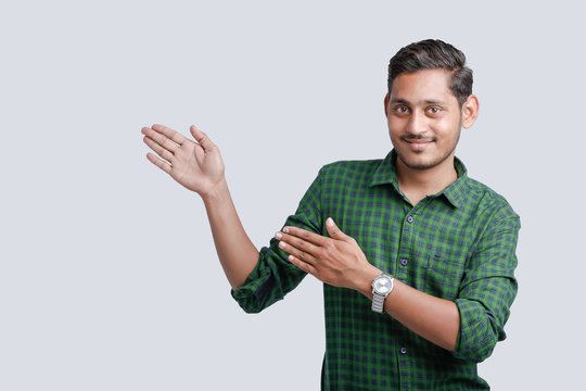young indian college student showing direction