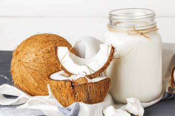 Coconut and  glass of coconut milk on  wooden background