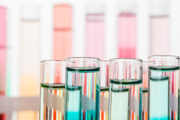 Glass laboratory chemical test tubes with liquid for analysis close up