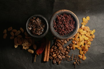 bowl with tobacco for hookah. berries on a black background