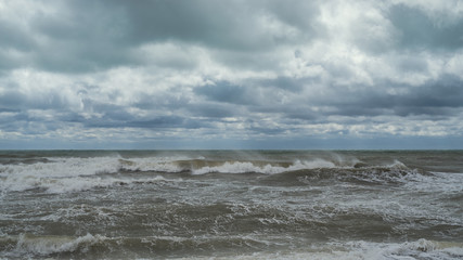Fototapeta na wymiar sea waves, windy weather against a cloudy cloudy sky.