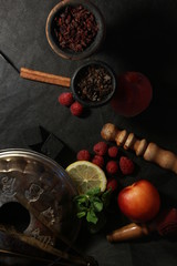 bowl with tobacco for hookah. berries on a black background