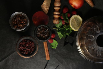 bowl with tobacco for hookah. berries on a black background