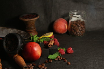 bowl with tobacco for hookah. fruits on a black background. smoke hookah