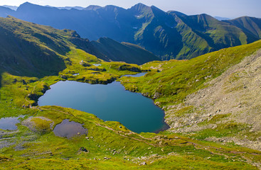 Fototapeta na wymiar Mountain summer lake in alpine area