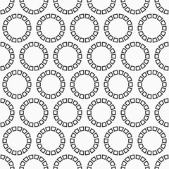 Abstract seamless pattern of repeating round ornaments isolated on white background.