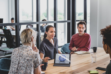 Hispanic businesswoman giving a presentation in a meeting