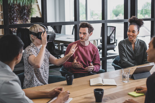 Coworkers discussing VR headset technology