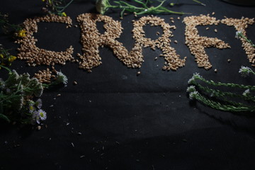 hops and malt on a black background
