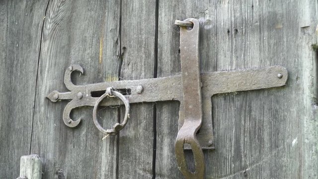 Close-up of an iron hasp lock on an old wood