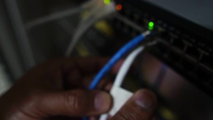 Computer engineers are repairing a network hub switch footage slow motion
