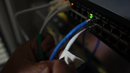Computer engineers are repairing a network hub switch footage slow motion