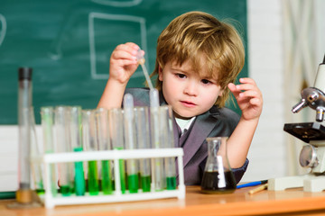 small boy study chemistry. testing tubes with liquid for research. learn for future. Biology science. result. Medical. Little genius child. small boy using microscope. Young confident scientist