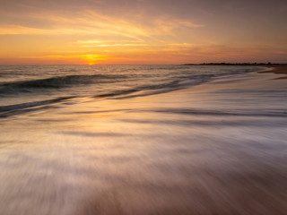 Fototapeta na wymiar Sunset on the beach of Trafalgar Lighthouse, Caños de Meca, Andalusia, Spain.