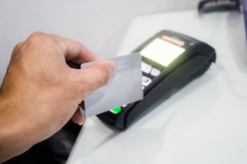  A portrait of EDC ( electronic Data Capture) machine , hand sweeping card on it.