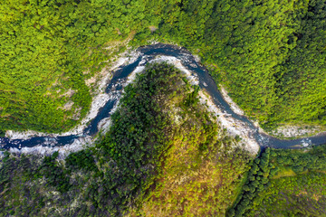 Aerial top-down view of a river crossing mountain range