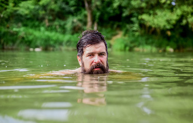 wild man. time to relax. bearded man swimming in lake. summer vacation. mature swimmer. brutal hipster with wet beard. refreshing in river water. water beast. furry monster