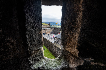 Looking through window at Stirling Castle with tourists and people, Stirling, Scotland, UK