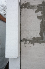 Insulation house wall outdoors. Installing rigid styrofoam insulation board for energy saving.  Polystyrene insulation.