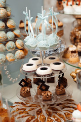 Banquet table full of fruits and berries and an assortment of sweets. Stylish luxury decorated candy bar for the celebration of a wedding of happy couple, catering in the restaurant
