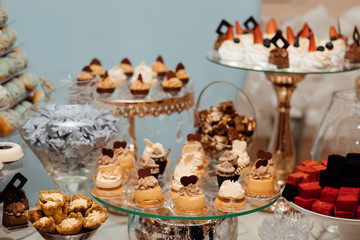 Banquet table full of fruits and berries and an assortment of sweets. Stylish luxury decorated candy bar for the celebration of a wedding of happy couple, catering in the restaurant